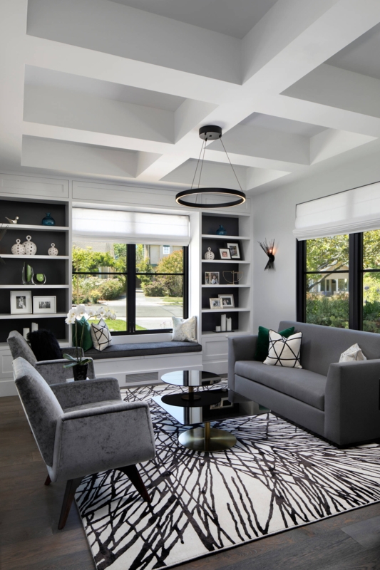 Grey Floor Living Room: Coffered Ceiling & Abstract Rug Design