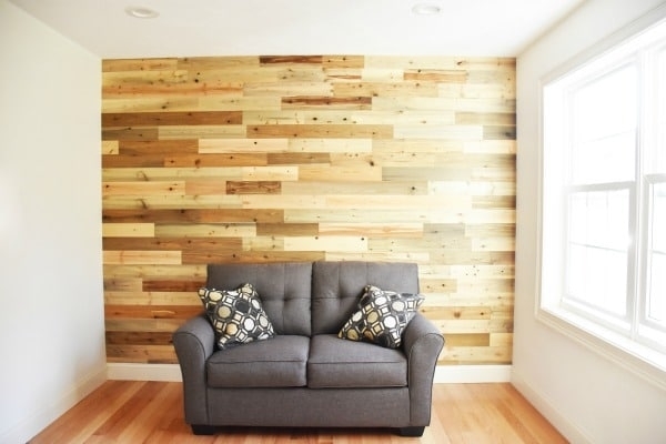 Grey Loveseat Against a Multi-Toned Wood Plank Wall