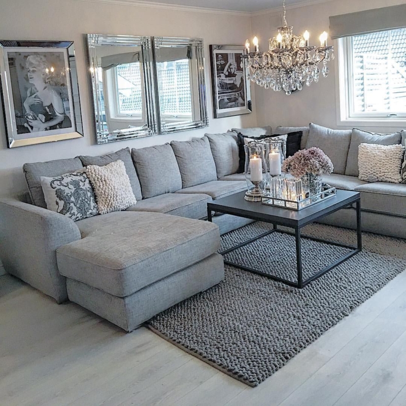 Grey Sectional Sofa with Mirrored Wall Decor and Chunky Knit Rug styling