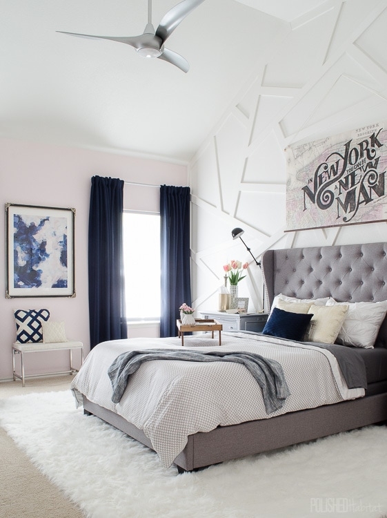 Grey Tufted Wingback Bed: Geometric Accent Wall & Navy Curtains