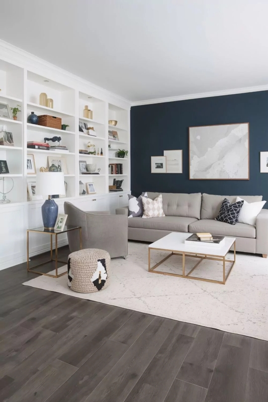Grey Wood Floor Living Room: Navy Accent Wall & Built-in Shelving