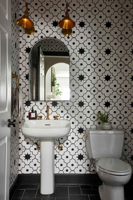 Half Bath Bold Geometric Wallpaper with Brass Fixtures and Arched Mirror