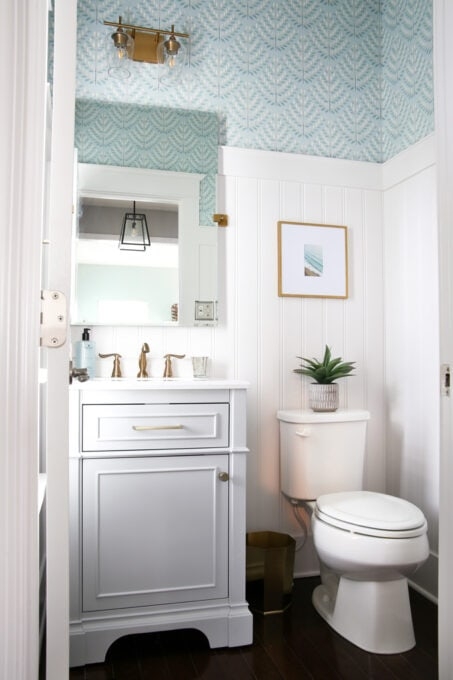 Half Bath Coastal Farmhouse: Beadboard Wainscoting and Gold Hardware