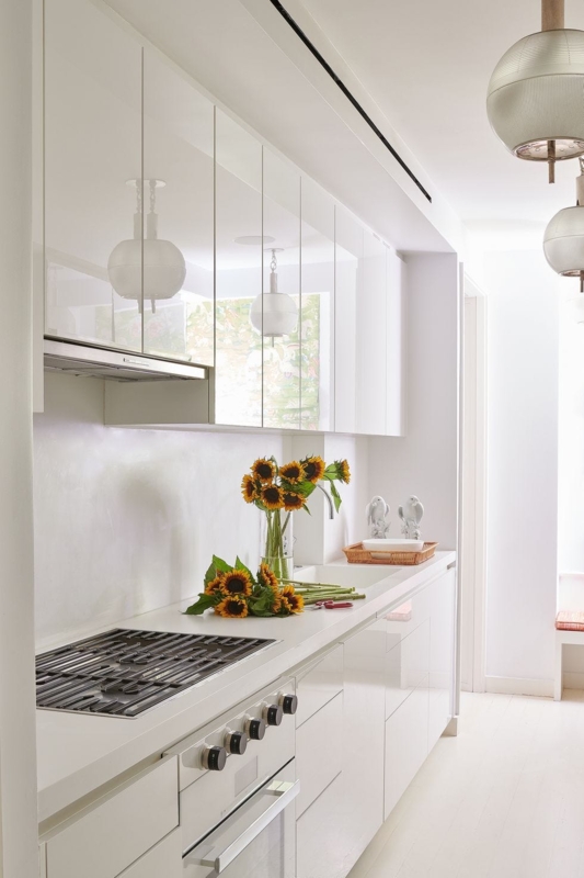 Handleless Galley Kitchen with High-Gloss White Cabinets