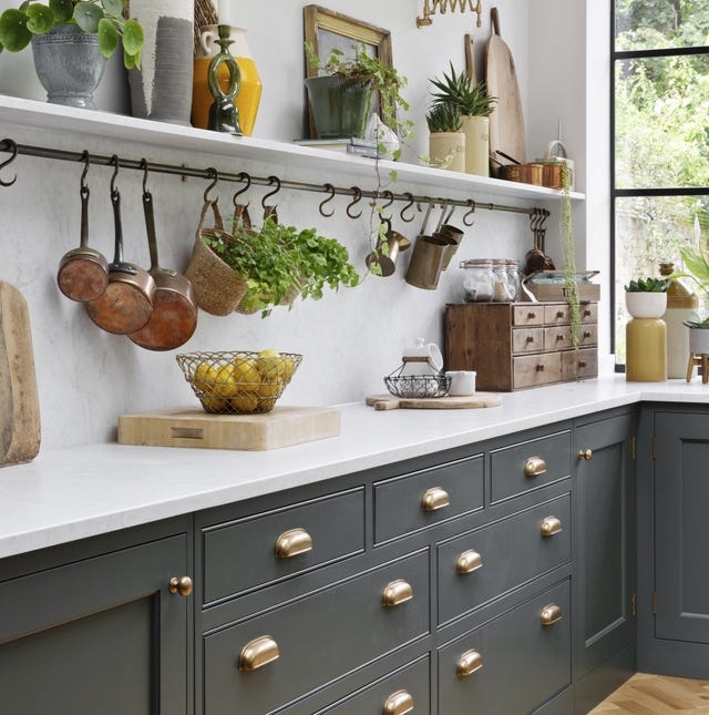 Hanging Pot Rack with Copper Accents over Dark Gray Shaker Cabinets