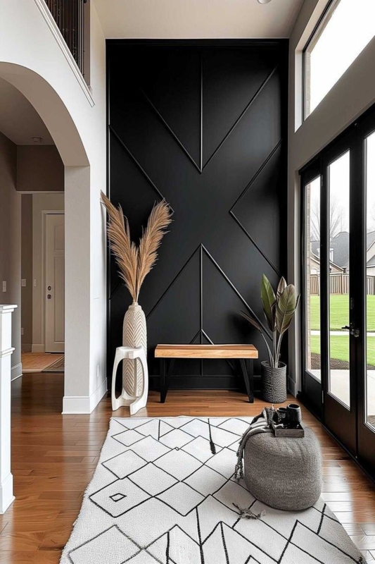 High Contrast Entryway Design: Dark Geometric Accent Wall and Wood Bench