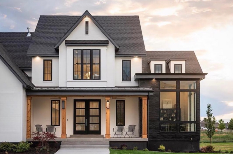 High Contrast Facade with Natural Wood Pillars and Large Windows