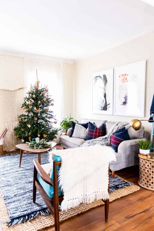 Holiday Living Room Layout with Natural Christmas Tree and Layered Rugs