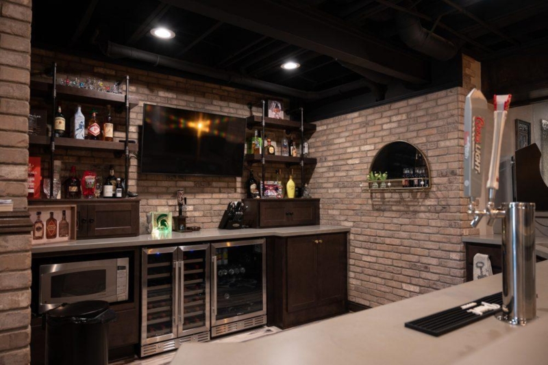 Home Bar with Dual Beverage Coolers and Industrial Pipe Shelving Layout