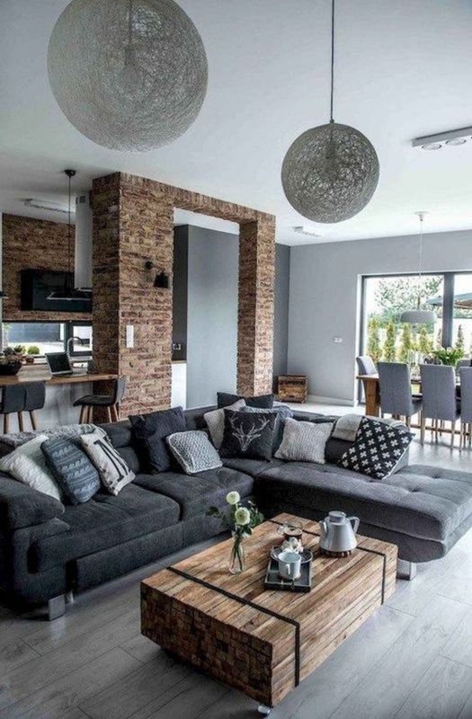 Industrial Grey Laminate Floor: Charcoal Sectional & Exposed Brick