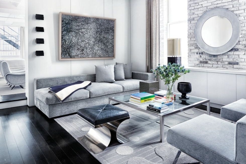 Industrial Living Room with Exposed Brick Wall and Sculptural Ottoman