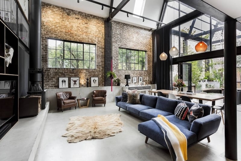 Industrial Loft Living Room: Black Steel Rafters, Blue Sectional Sofa