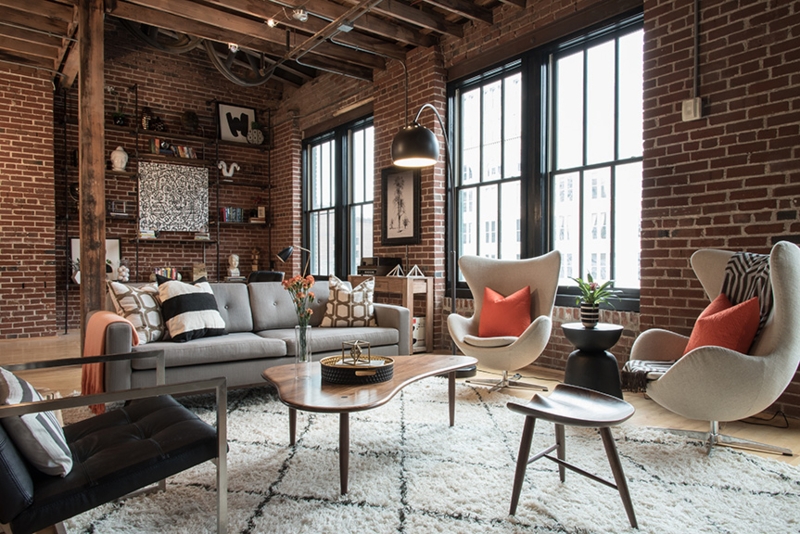 Industrial Loft Living Room: Exposed Brick, Wood Beams & Egg Chairs