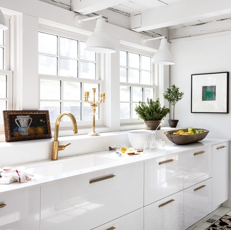 Kitchen Cabinetry High Gloss White with Brass Hardware and Large Windows