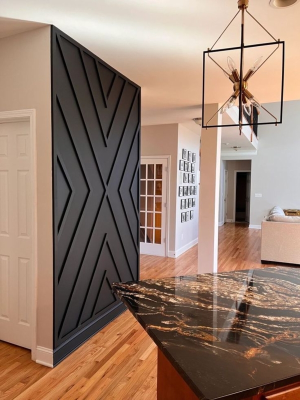 Kitchen featuring Black Geometric Accent Wall and Marbled Island