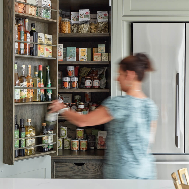 Kitchen Pantry with Sage Green Finish and Wood-Lined Interior