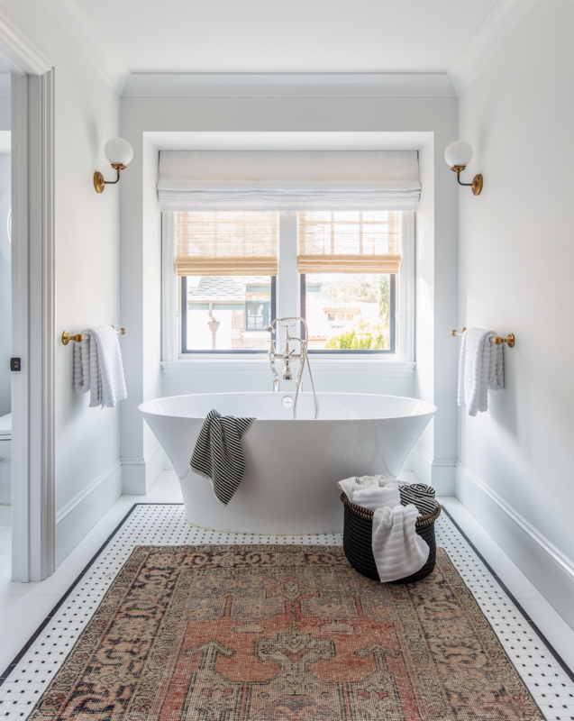 Layered Roman Shades and Woven Blinds in Symmetrical Bathroom