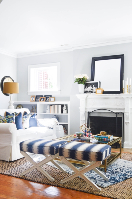 Layered Rugs and Striped X-Base Ottomans in Transitional Living Room