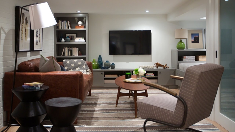 Leather-Like Sofa and Striped Chair in Mid Century Modern Basement