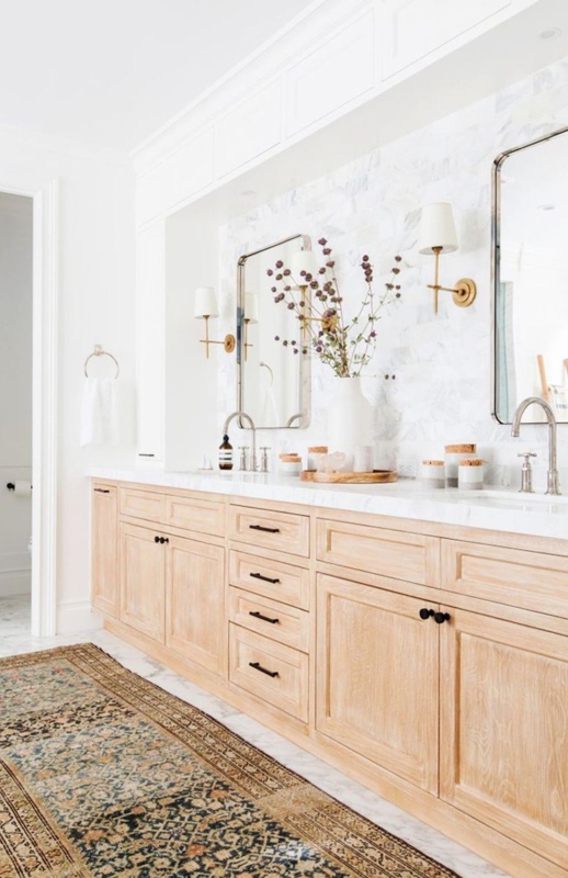 Light Oak Double Vanity, Marble Mosaic Backsplash, Brass Sconces