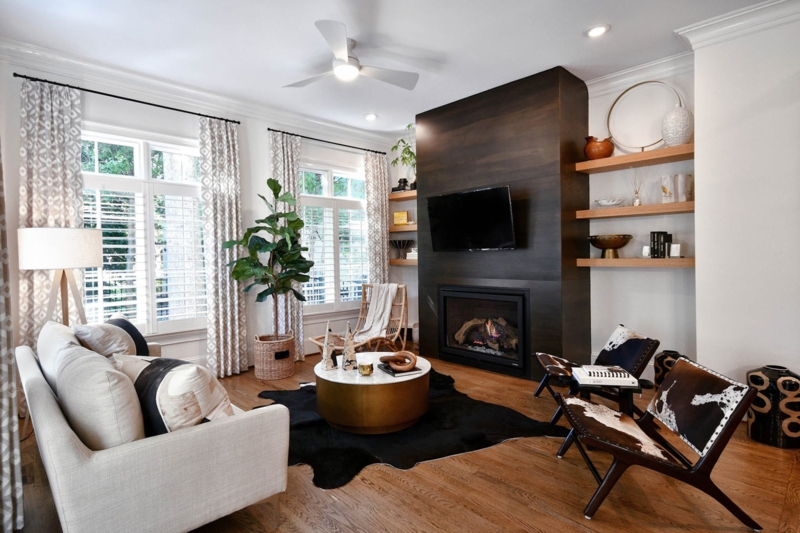 Living Room: Dark Wood Fireplace Wall Ideas with Cowhide Print Chairs.