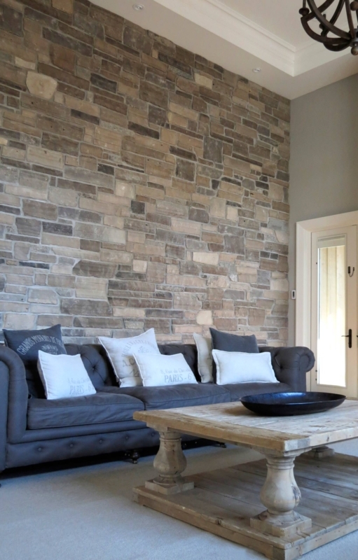 Living Room Design: Stacked Stone Wall and Grey Tufted Chesterfield Sofa