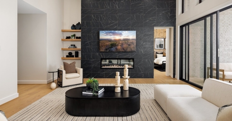 Living Room featuring Black Marble Tiled Wall and Linear Fireplace