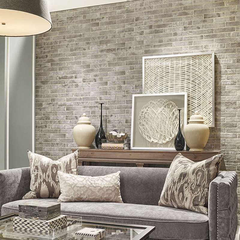 Living Room: Gray Brick Accent Wall behind Tufted Sofa and Wood Console