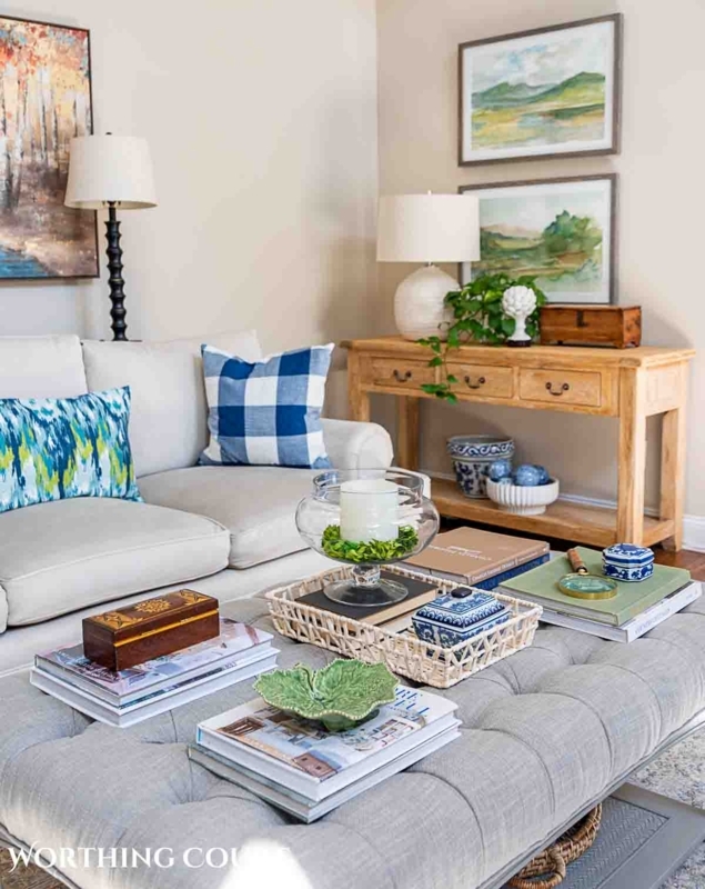 Living Room Ottoman Coffee Table Styling With Layered Wall Art Layout
