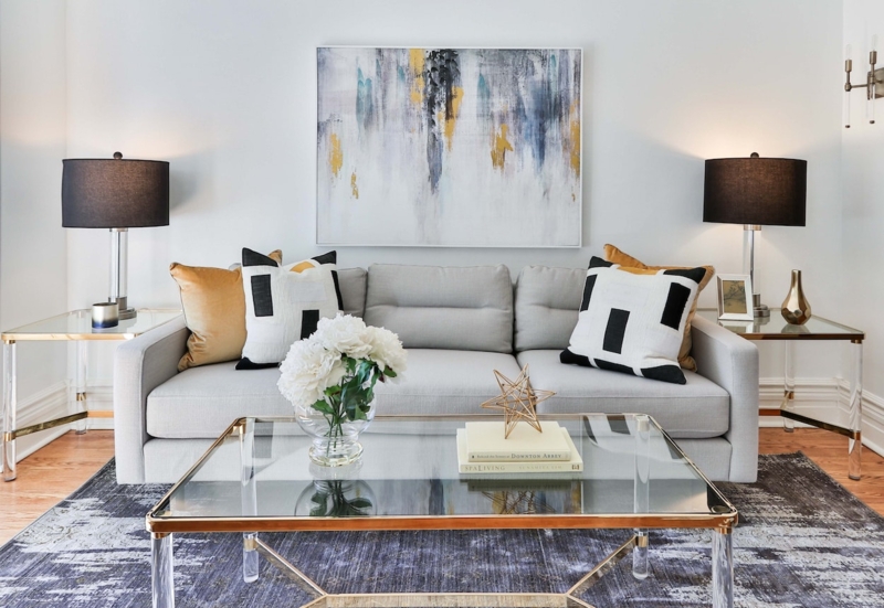Living Room Symmetrical Lighting with Gold and Glass Coffee Table