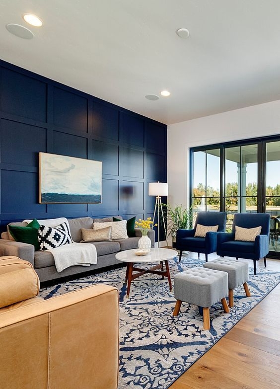 Living Room with Blue Rug: Navy Paneled Wall and Mixed Seating Layout