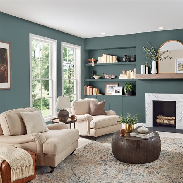 Living Room with Deep Teal Walls, Marble Fireplace and Built-in Shelving