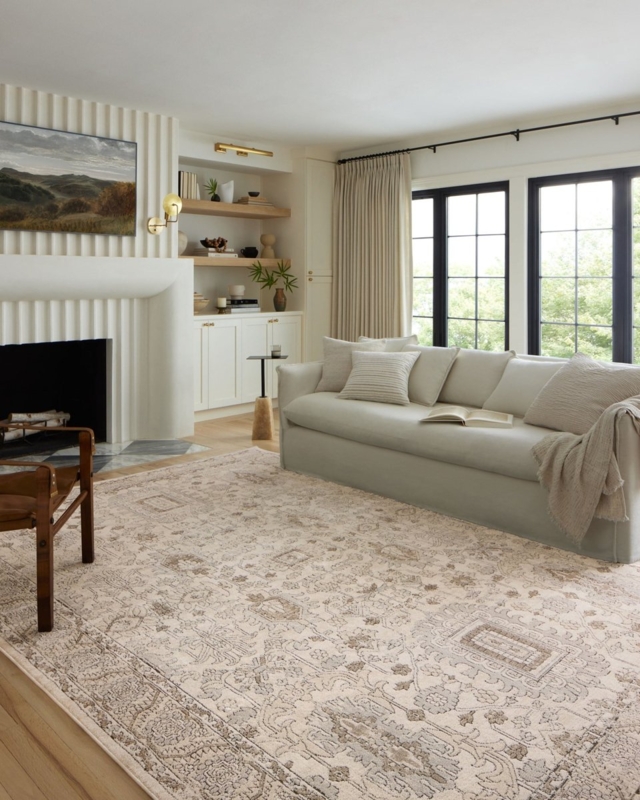 Living Room with Fluted Fireplace and Neutral Patterned Area Rug Ideas