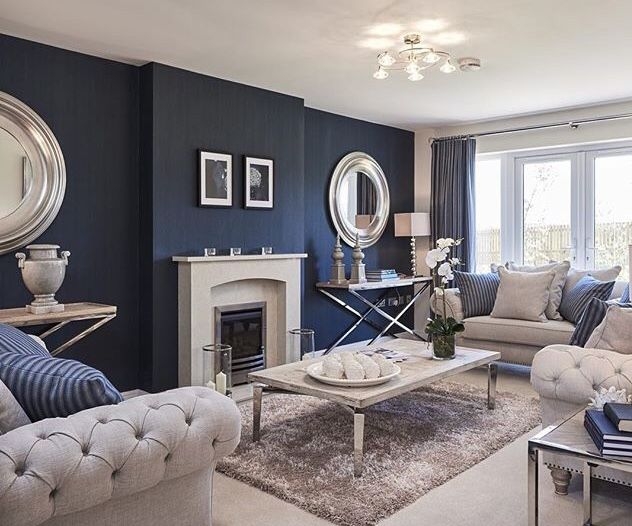Living Room with Navy Blue Walls and Oversized Silver Mirrors