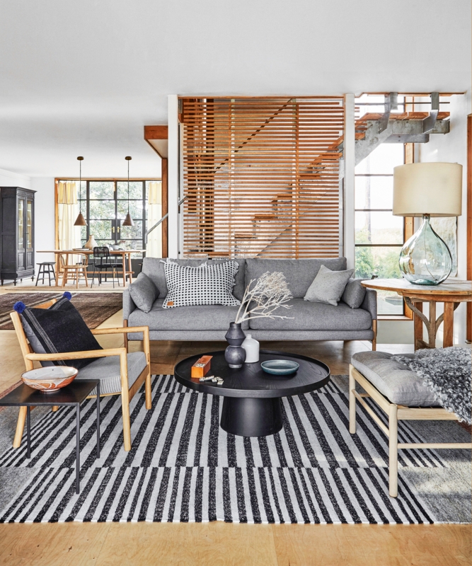 Living Room with Slatted Wood Screen & Bold Striped Rug