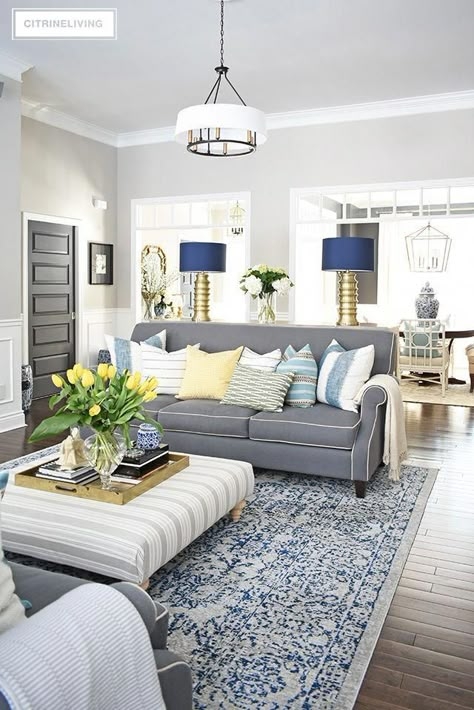 Living Room with Striped Ottoman Coffee Table and Navy Drum Shades