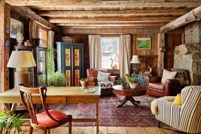 Log Cabin Living Room with Exposed Beams and Hand-Painted Armoire
