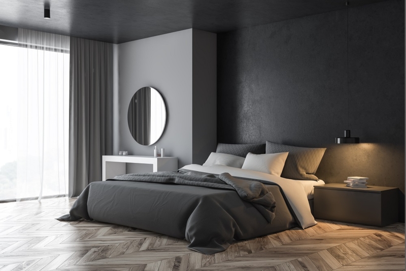 Low-Profile Bed with Charcoal Accent Wall and Herringbone Floors