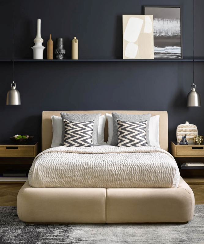 Low Profile Upholstered Bed against Dark Accent Wall with Shelf