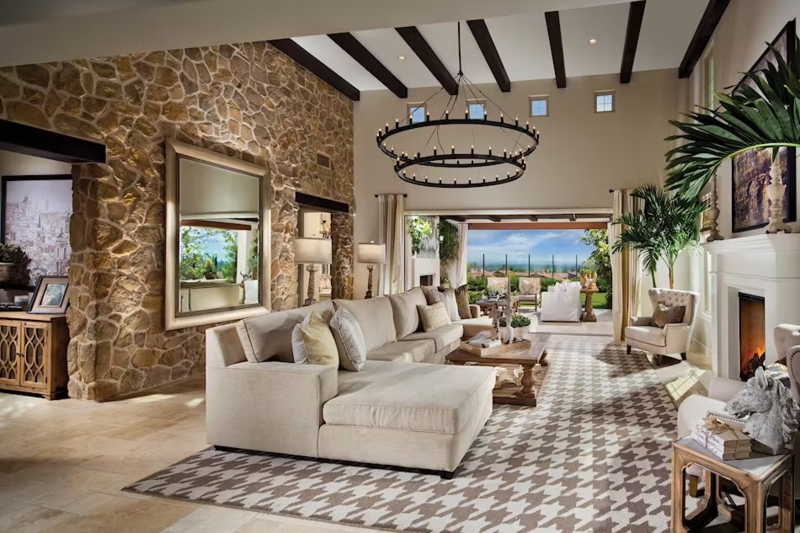 Luxurious Great Room with Massive Stone Wall and Rustic Exposed Beams