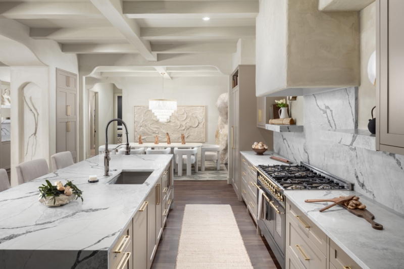Luxury Kitchen featuring Marble Waterfall Island and Plaster Vent Hood