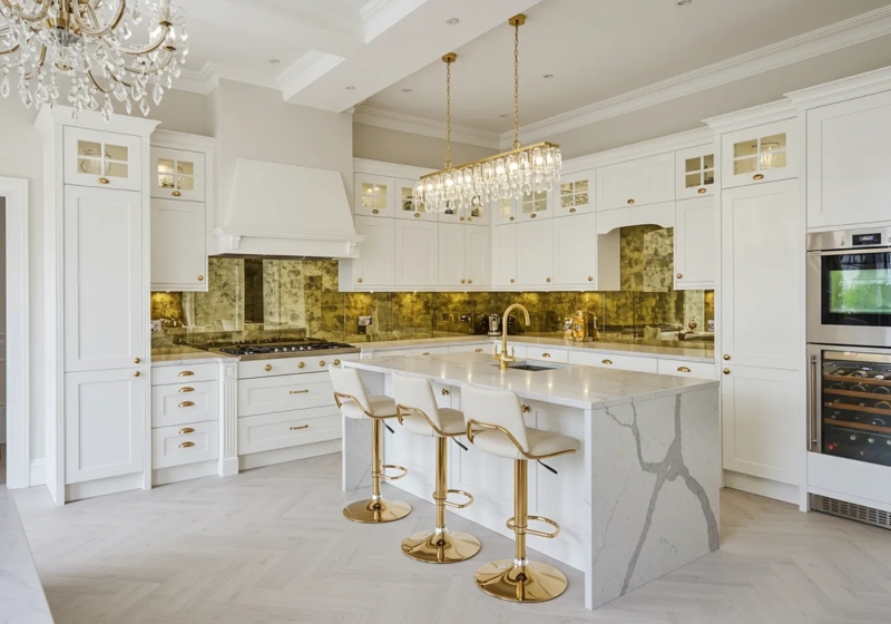 Luxury White Kitchen with Antique Mirror Backsplash and Waterfall Island