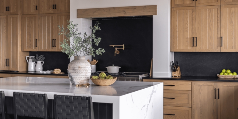 Marble Waterfall Island contrasted by a Matte Black Backsplash
