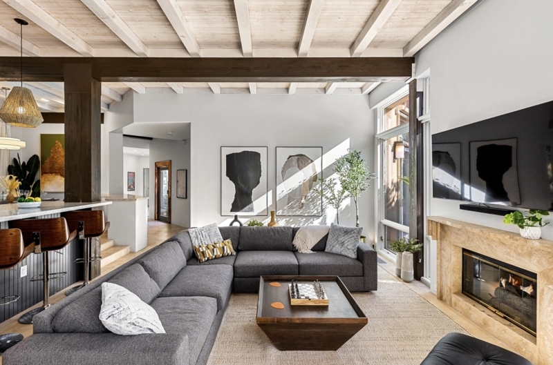 Masculine Living Room with Exposed Ceiling Beams and Grey Sectional