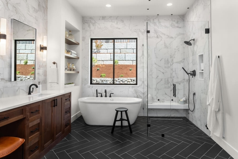 Master Bathroom with Dark Herringbone Floor and Freestanding Tub