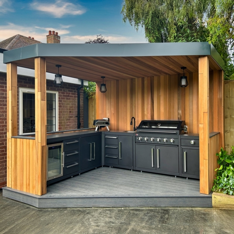 Matte Black Outdoor Cabinetry: L-Shaped Modular Units in Wood Pavilion