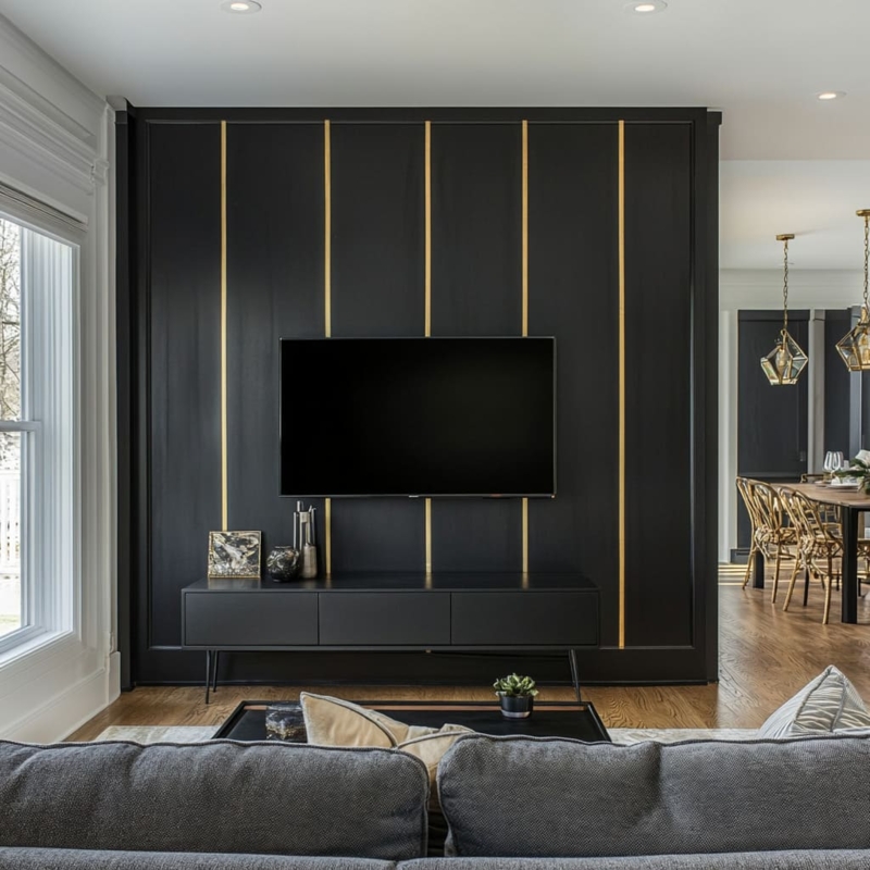 Matte Black Wall with Vertical Brass Inlay Strips behind TV Stand