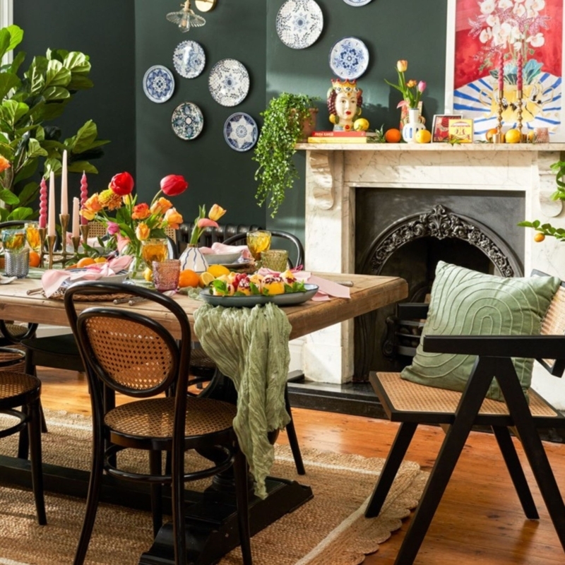 Maximalist Dining Room with Dark Green Walls & Cane Chairs