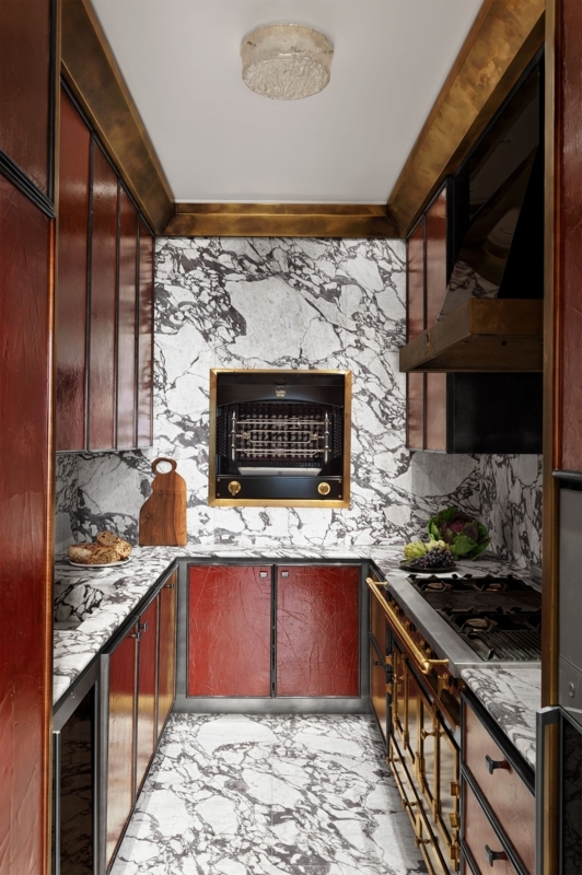 Maximalist Kitchen with Burgundy Textured Cabinets and Brass Trim