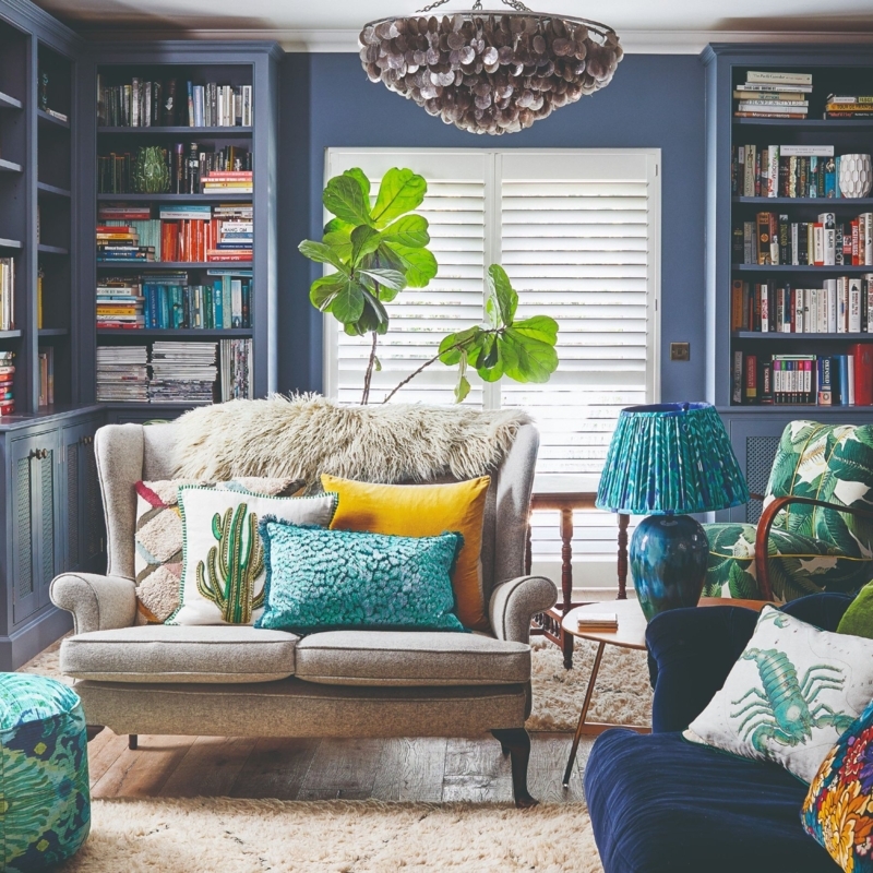 Maximalist Loveseat with Built-In Bookcases and Navy Walls